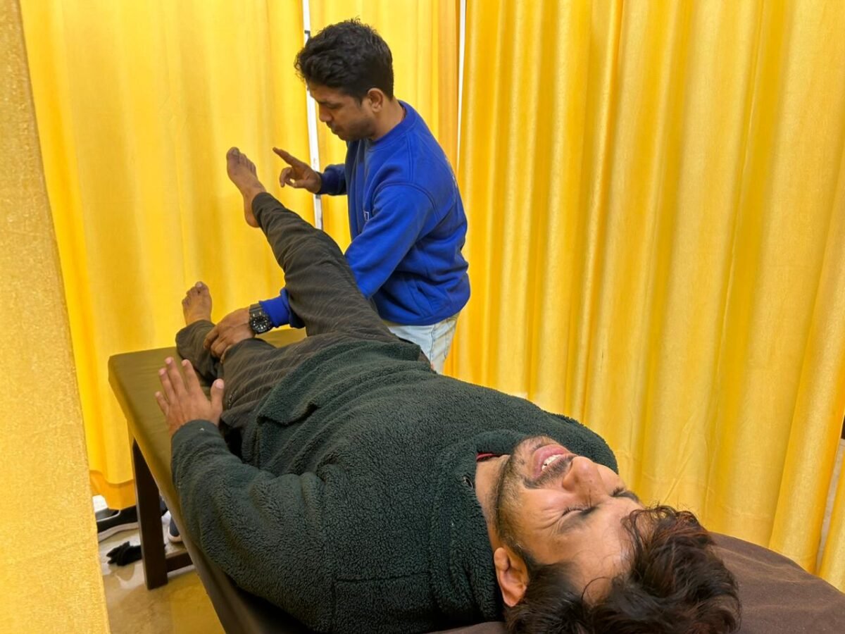 Physical therapist helping individual with exercises